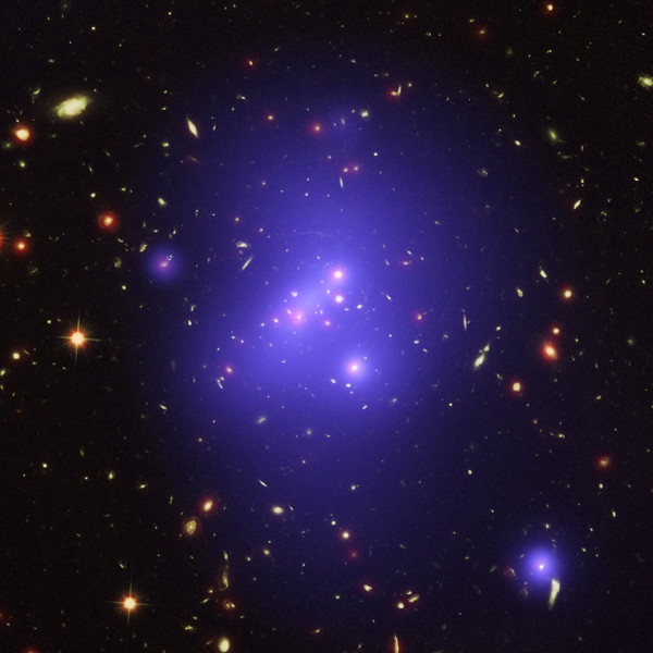 This optical/X-ray/infrared composite of the galaxy cluster IDCS J1426.5+3508 reveals the most massive cluster ever found at such a high redshift. Image composite credit: X-ray: NASA/CXC/Univ of Missouri/M.Brodwin et al; Optical: NASA/STScI; Infrared: JPL/CalTech.
