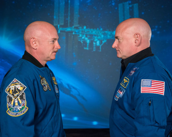 Mark and Scott Kelly at the Johnson Space Center, Houston Texas; one spent a year in space (and aged slightly less) while the other remained on the ground. Image credit: NASA.