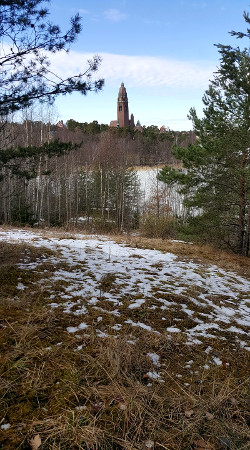 In the foreground, a characteristic Swedish archaeological site of the 20th century: the abandoned municipal ski slope. Its construction, use and abandonment all post-date the still-in-use 1913 building in the background.