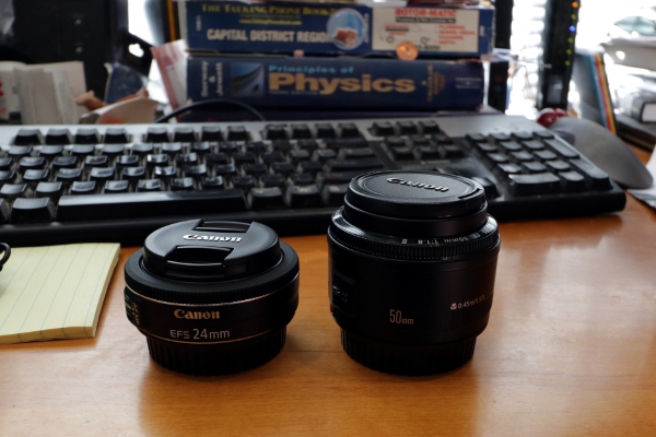 On the right, the f/1.8 50mm lens I've had for a while. On the left, the f/2.8 24mm lens that arrived today.