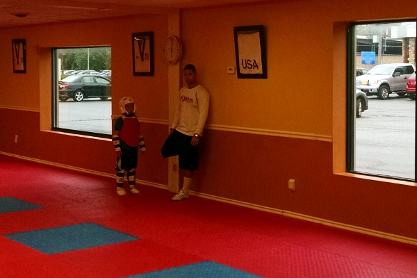 SteelyKid, in sparring gear, with her taekwondo coach.