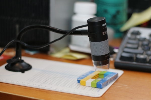 SteelyKid's digital microscope looking at hair on a Lego frame.