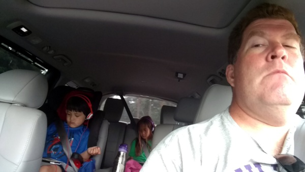 Selfie in the car with the kids engrossed in their tablets. 
