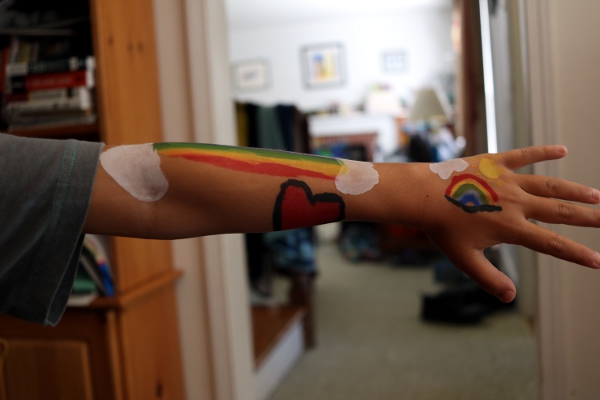 SteelyKid's arm, covered with rainbows that she mostly painted herself.