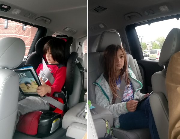 SteelyKid (r) and The Pip in the car, reading.