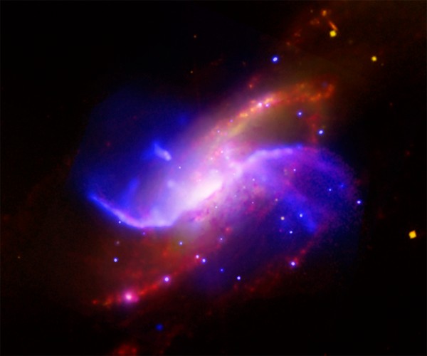 Image credit: X-ray (blue): NASA/CXC/Univ. of Maryland/A.S. Wilson et al.; Optical (white): Pal.Obs. DSS; IR (red): NASA/JPL-Caltech; VLA: NRAO/AUI/NSF.