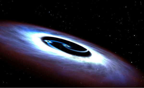 Image credit: Image credit: NASA, ESA and G. Bacon (STScI), of a binary black hole. Loeb’s idea is that these binary black holes could exist inside a single star.