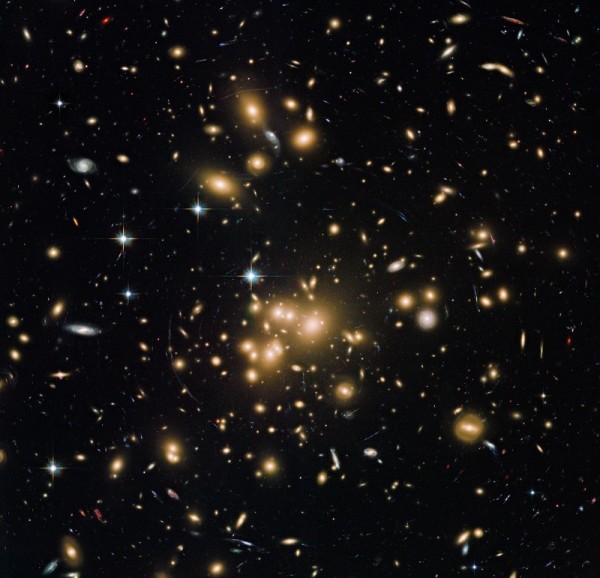A massive, distant galaxy cluster as imaged by Hubble, showcasing a number of phenomena supported by dark matter. Image credit: NASA, ESA, the Hubble Heritage Team (STScI/AURA), J. Blakeslee (NRC Herzberg Astrophysics Program, Dominion Astrophysical Observatory), and H. Ford (JHU).