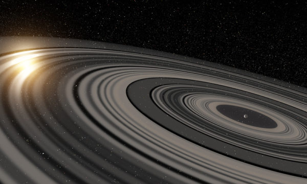 Artist’s conception of the extrasolar ring system circling the young giant planet or brown dwarf J1407b. Image credit: Ron Miller.