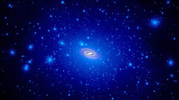 From simulations and inferred maps, dark matter (blue) may form some clumps, but overall exists in a massive, diffuse halo around the luminous, disk-like part of galaxies we're familiar with. Image credit: NASA, ESA, and T. Brown and J. Tumlinson (STScI).