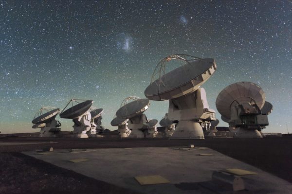 The Atacama Large Millimetre/submillimetre Array, as photographed with the Magellanic clouds overhead. Image credit: ESO/C. Malin.