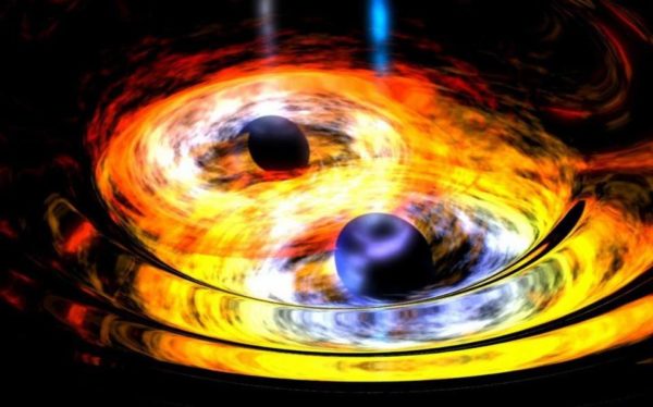 Artist's impression of two merging black holes, with accretion disks. The density and energy of the matter here should be insufficient to create gamma ray or X-ray bursts. Image credit: NASA / Dana Berry (Skyworks Digital).