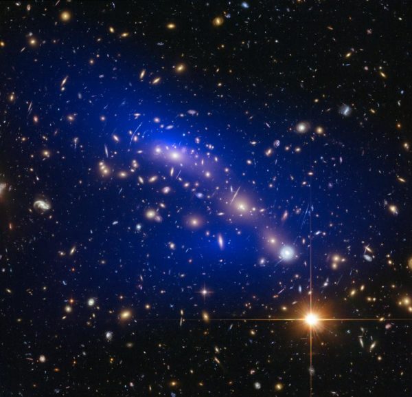 The ultramassive, merging dynamical galaxy cluster Abell 370, with gravitational mass (mostly dark matter) inferred in blue. Image credit: NASA, ESA, D. Harvey (Swiss Federal Institute of Technology), R. Massey (Durham University, UK), the Hubble SM4 ERO Team and ST-ECF.