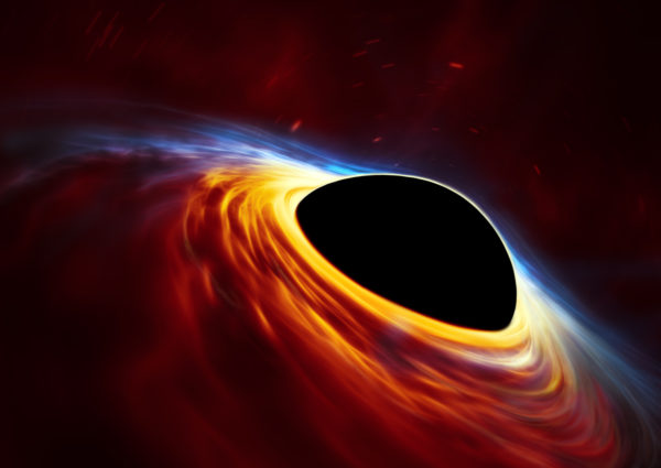 This artist’s impression depicts a rapidly spinning supermassive black hole surrounded by an accretion disc. A tidally disrupted star may be responsible for the matter, and for the luminous emissions that result. Image credit: ESA/Hubble, ESO, M. Kornmesser.
