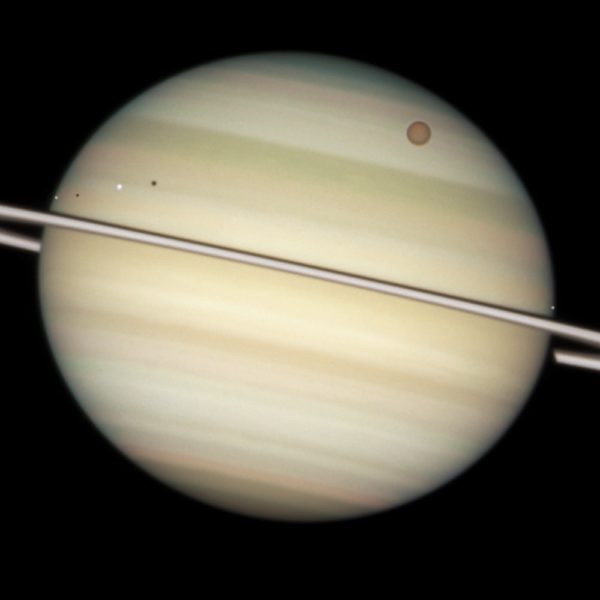 The ringed planet, Saturn, contains a number of interesting Moons. But the largest, Titan, isn't the source of mystery that the smaller Iapetus is. Image credit: NASA, ESA and the Hubble Heritage Team (STScI/AURA). Acknowledgment: M. Wong (STScI/UC Berkeley) and C. Go (Philippines).
