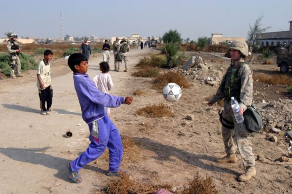 Hospital Corpsmen 3rd Class Tarren C. Windham kicks a soccer ball with an Iraqi child. That soccer ball is approximately the size of the Universe we see today at the moment of its birth. Image credit: U.S. Marine Corps photo by Gunnery Sgt. Chago Zapata.